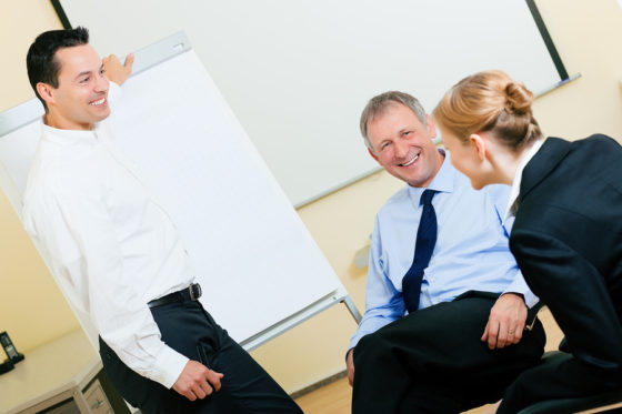 Business team receiving a presentation held by a male co-worker